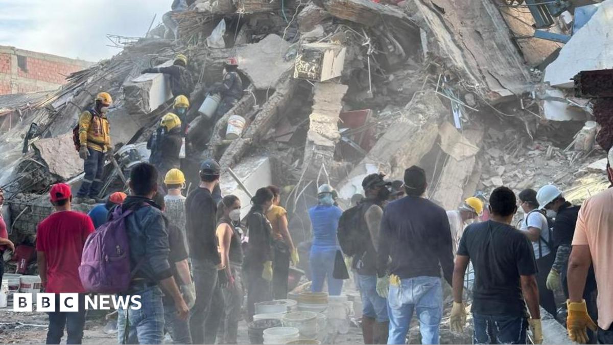 Firefighters react as they rescue a person following an earthquake, in Cali, Colombia, August 11, 2026 - one can be seen prominently in the middle, holding his arm up and appearing to shout