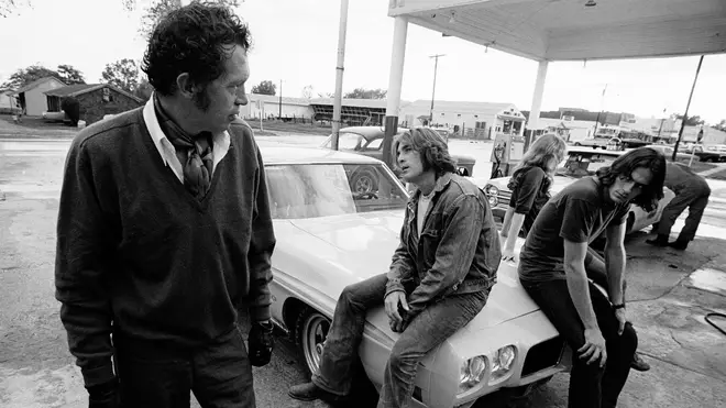 Warren Oates sizes up James Taylor and Dennis Wilson in the cult classic Two Lane Blacktop (1971).