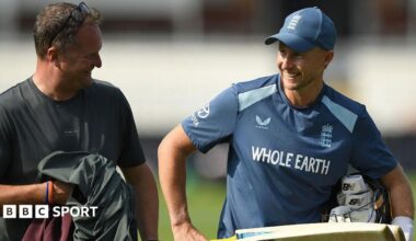 England Test captain Joe Root holding a bat and talking to Rob Key