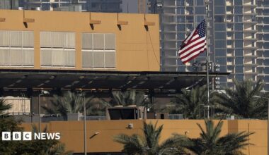 The US flag flutters outside the US Embassy, seen across the Tigris River in Baghdad's fortified Green Zone in March 2026