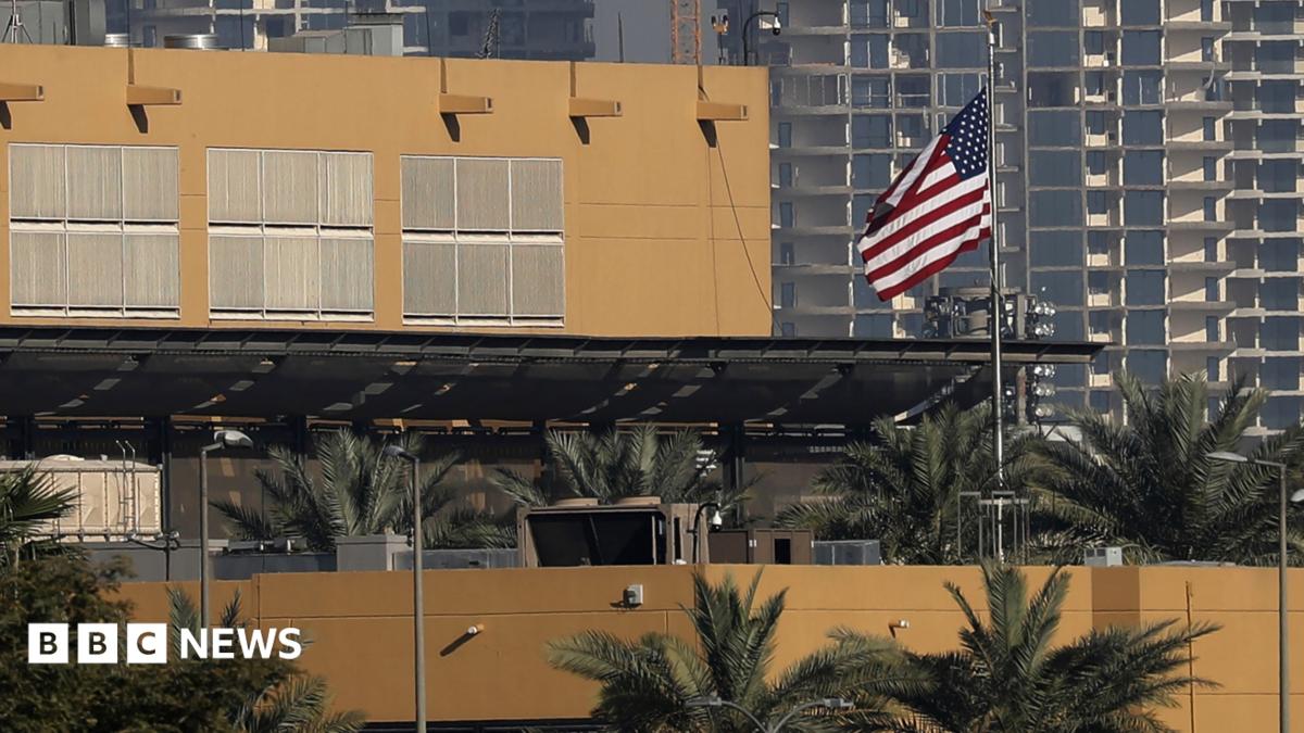 The US flag flutters outside the US Embassy, seen across the Tigris River in Baghdad's fortified Green Zone in March 2026