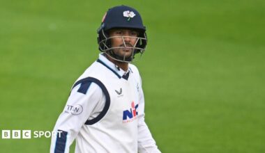 Mayank Agarwal looking upwards as he leaves the field with his bat in his right hand and helmet on in Yorkshire colours