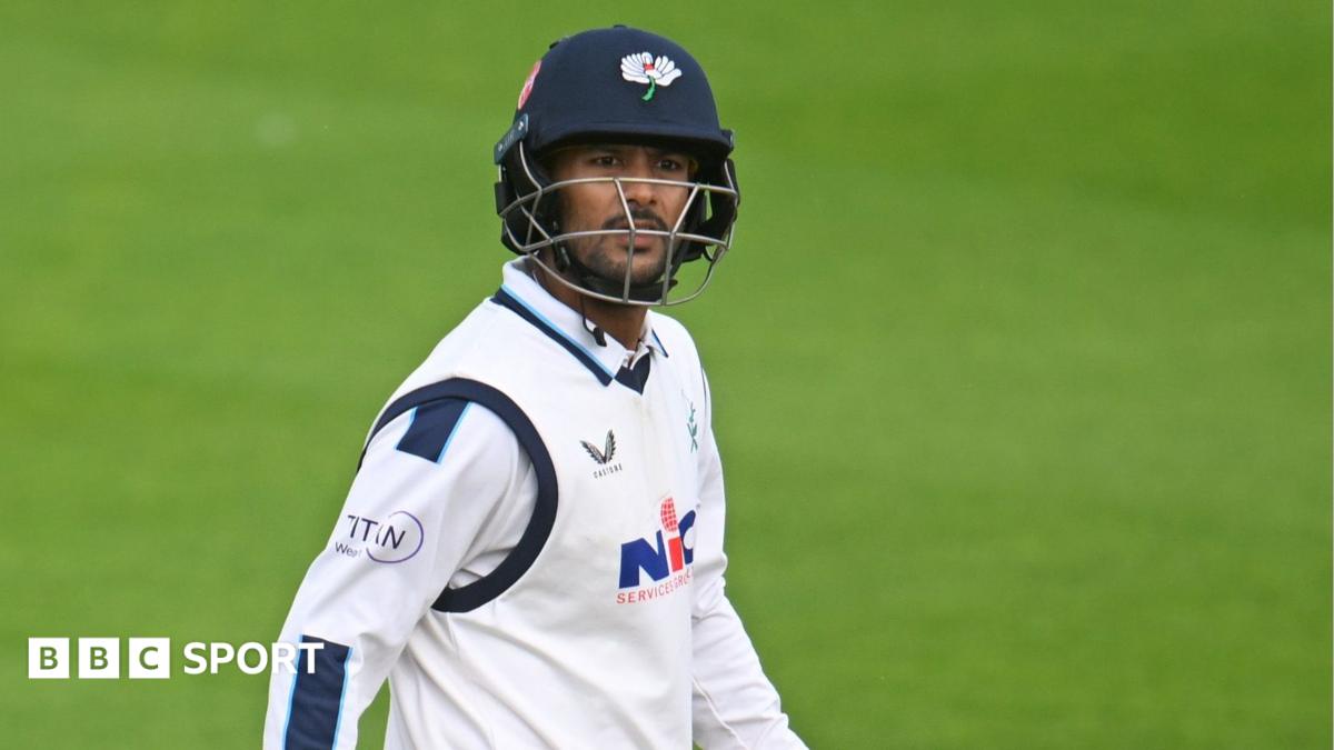 Mayank Agarwal looking upwards as he leaves the field with his bat in his right hand and helmet on in Yorkshire colours