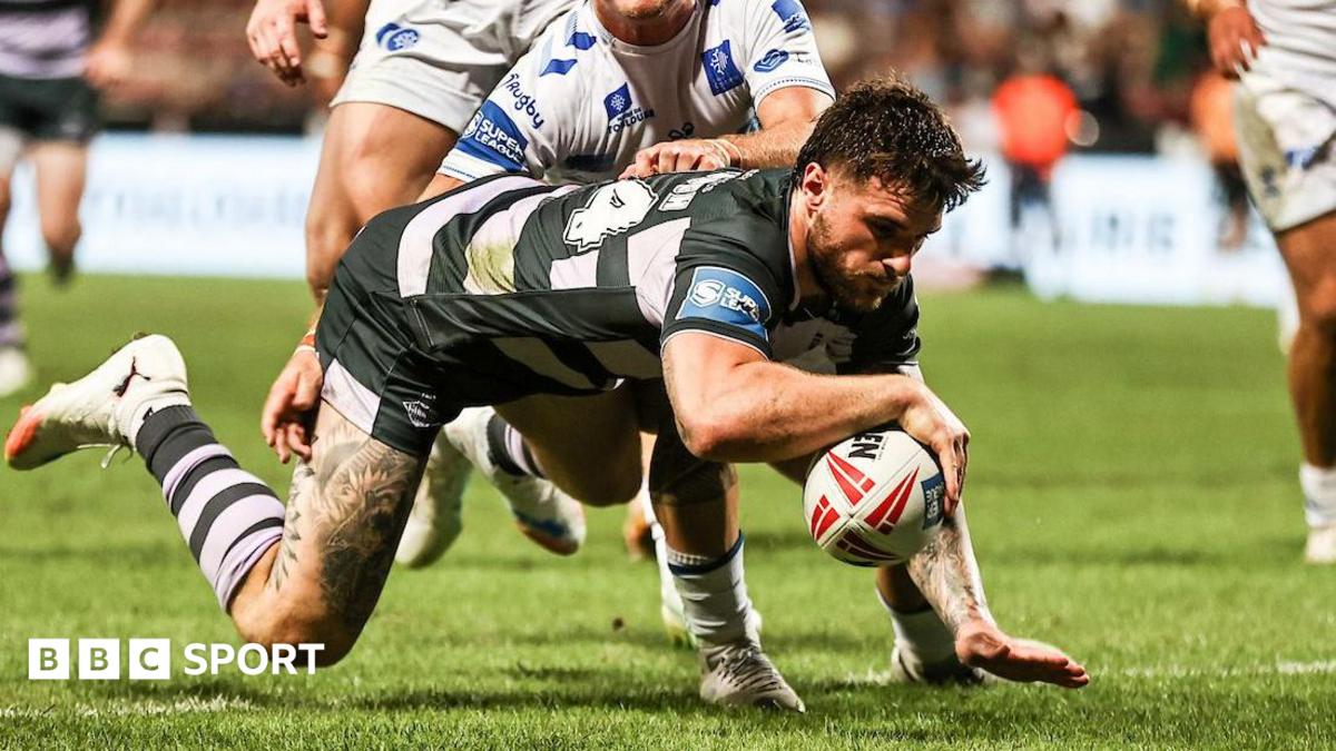 Connor Wrench, of Huddersfield Giants, extending over with his right arm to score a try.