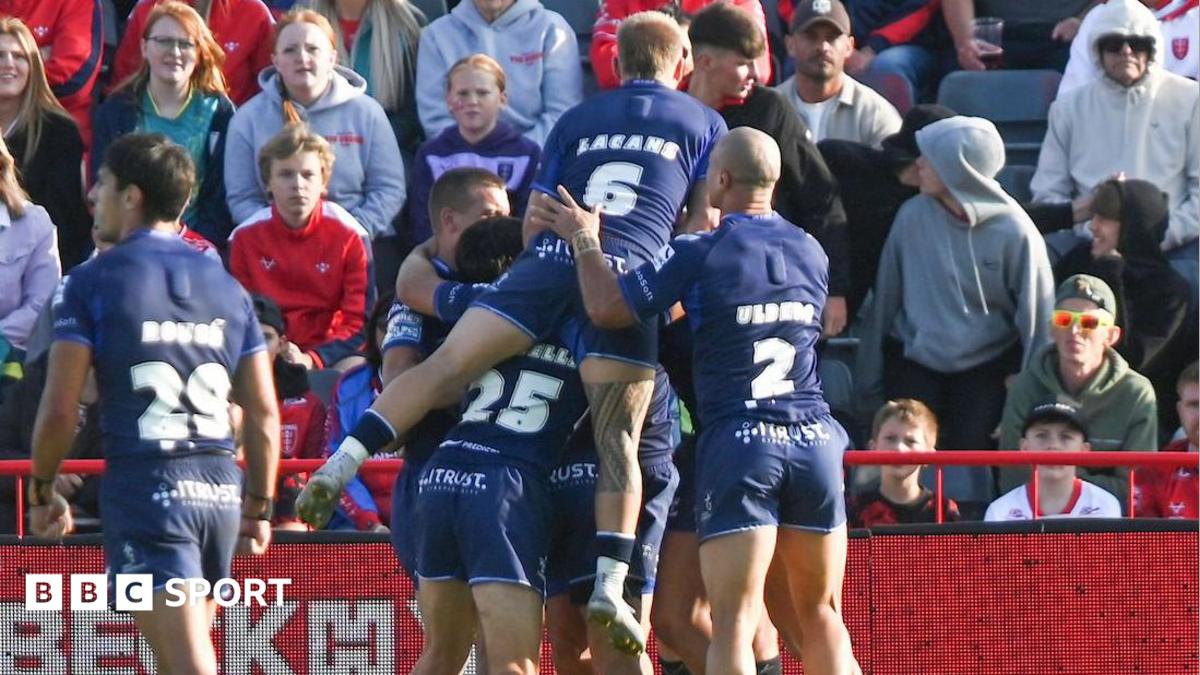 Toulouse players in blue kits jump on Mathieu Jussaume in celebration after he scored their first try in their win over Hull KR