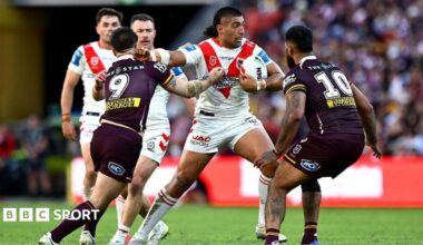 A charging Emre Guler fends off a Brisbane Broncos defender during a match in May