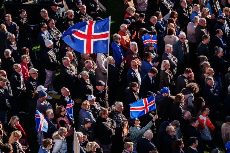 People with Icelandic flags attend an "Afram Island", "Forward, Iceland", rally, opposing the resumption of European Union accession talks 