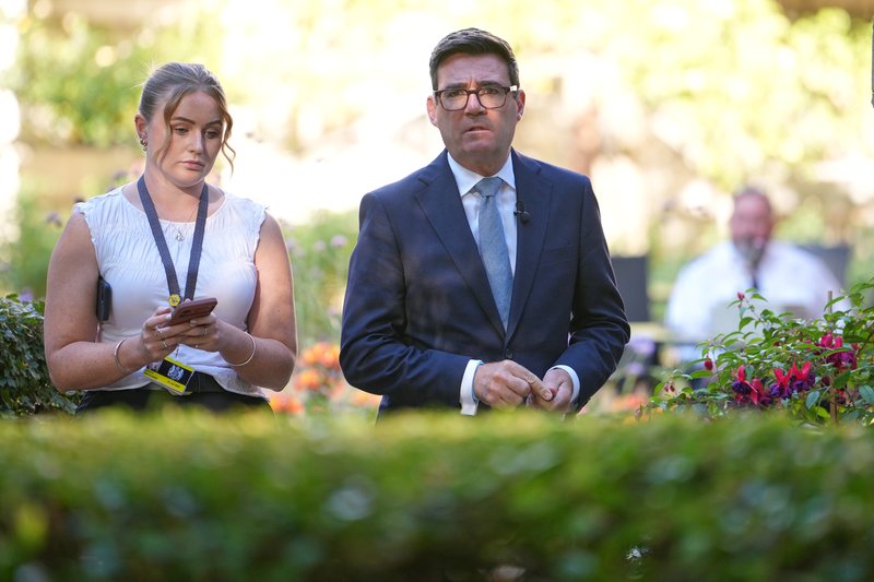 UK Prime Minister Andy Burnham walking to a meeting