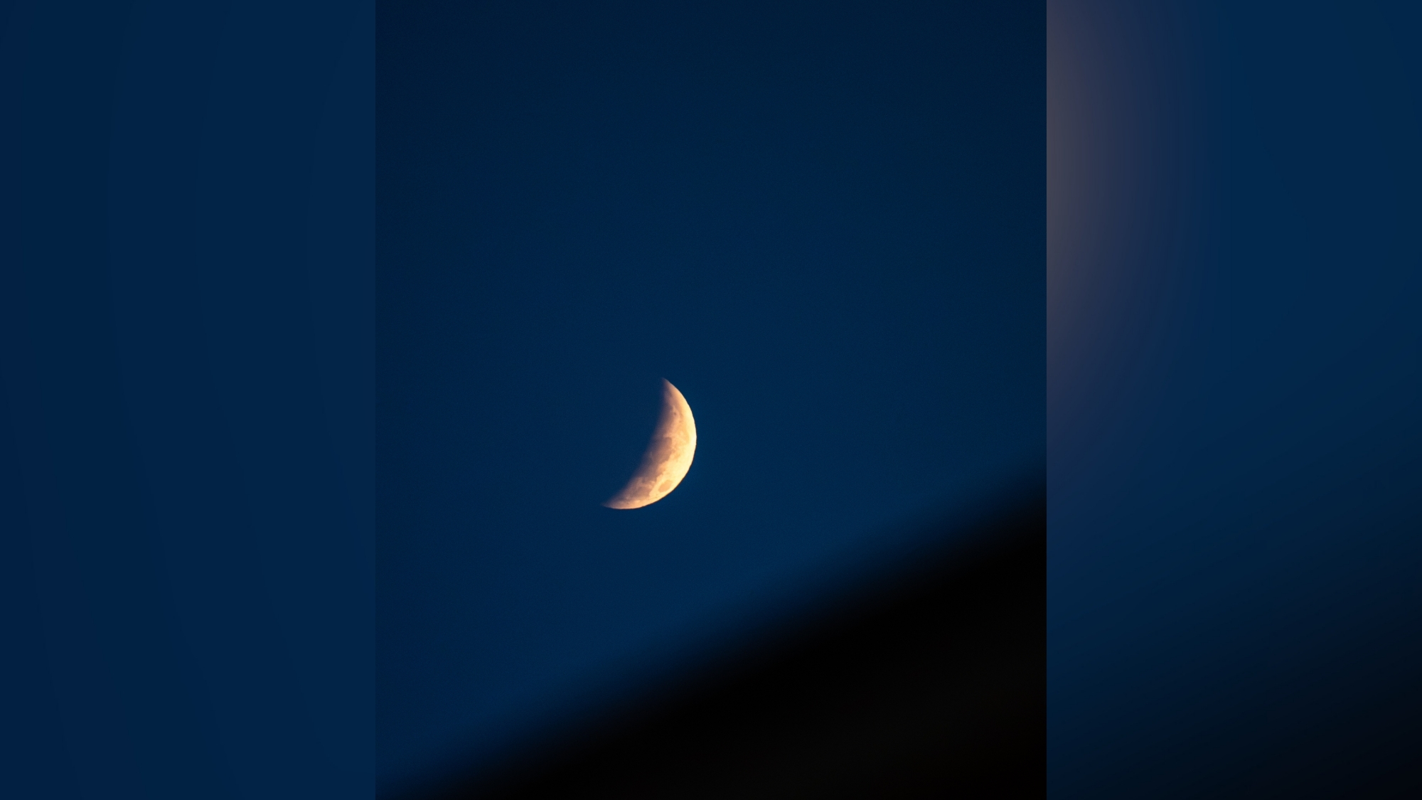 close up view of the partial lunar eclipse showing less than half illuminated moon.