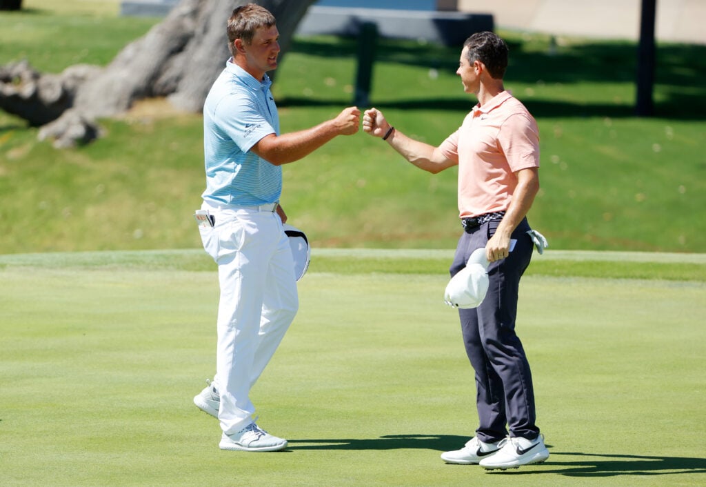 Bryson DeChambeau and Rory McIlroy fist bump after the final round of the Charles Schwab Challenge