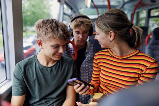 Teenage kids travelling by double decker bus in Bristol, United Kingdom