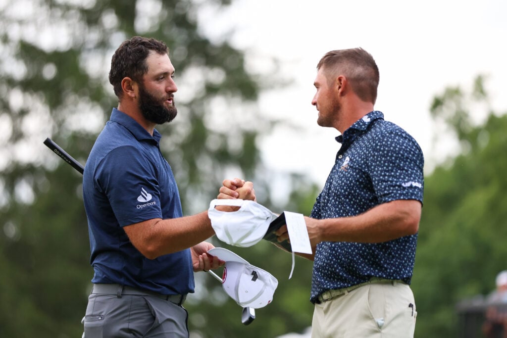 Jon Rahm of Spain hand shakes Bryson DeChambeau of the United States after finishing the 18th hole during day one of LIV Golf