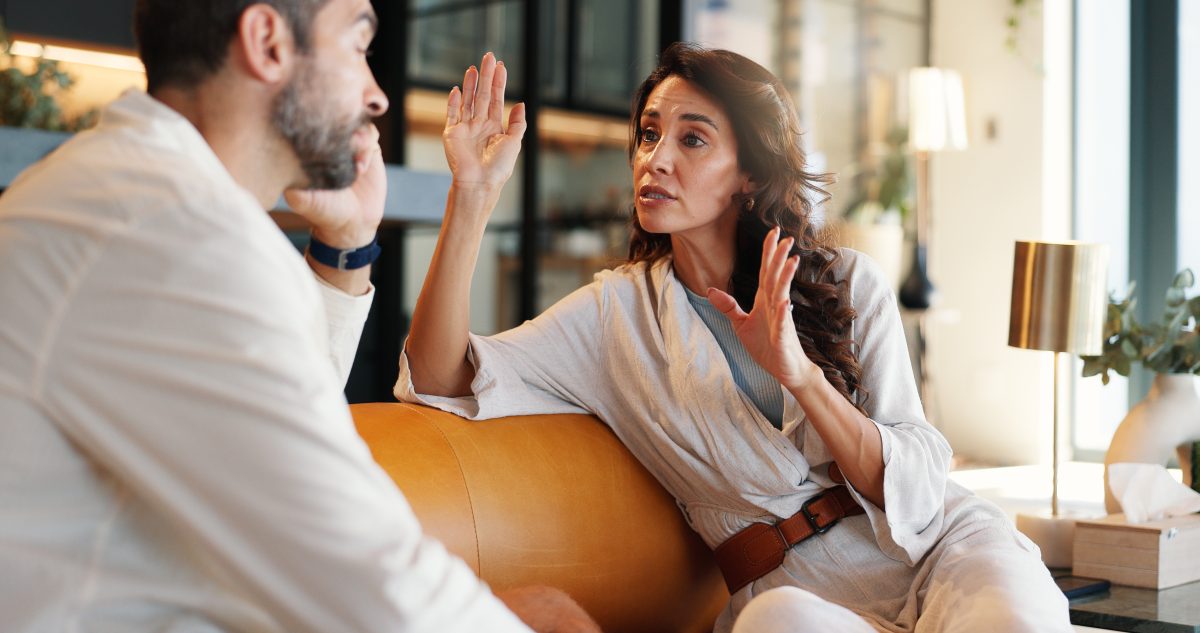 Couple, talk and arguing with fight at house for disagreement, conflict and divorce discussion. Woman, explain and bored man for conversation, toxic relationship and drama and marriage fail in lounge - stock photo
