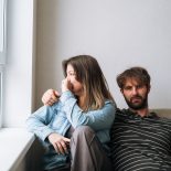 Unhappy married couple facing away from each other in a quiet home, concept of emotional distance, loneliness in relationship and family problems - stock photo