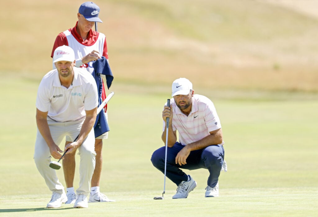 Wyndham Clark and Scottie Scheffler line up their putts on the third green during the final round of the 126th U.S. OPEN at Shinnecock Hills Golf Club