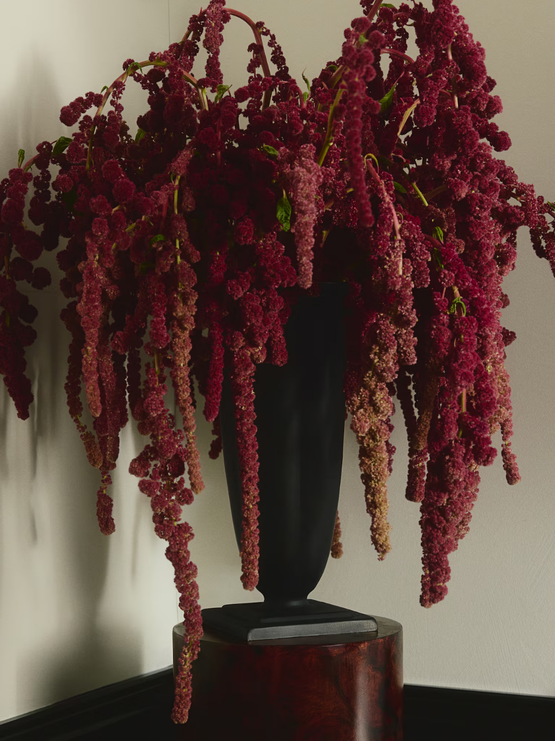 A black fluted vase from H&amp;M with red amaranth