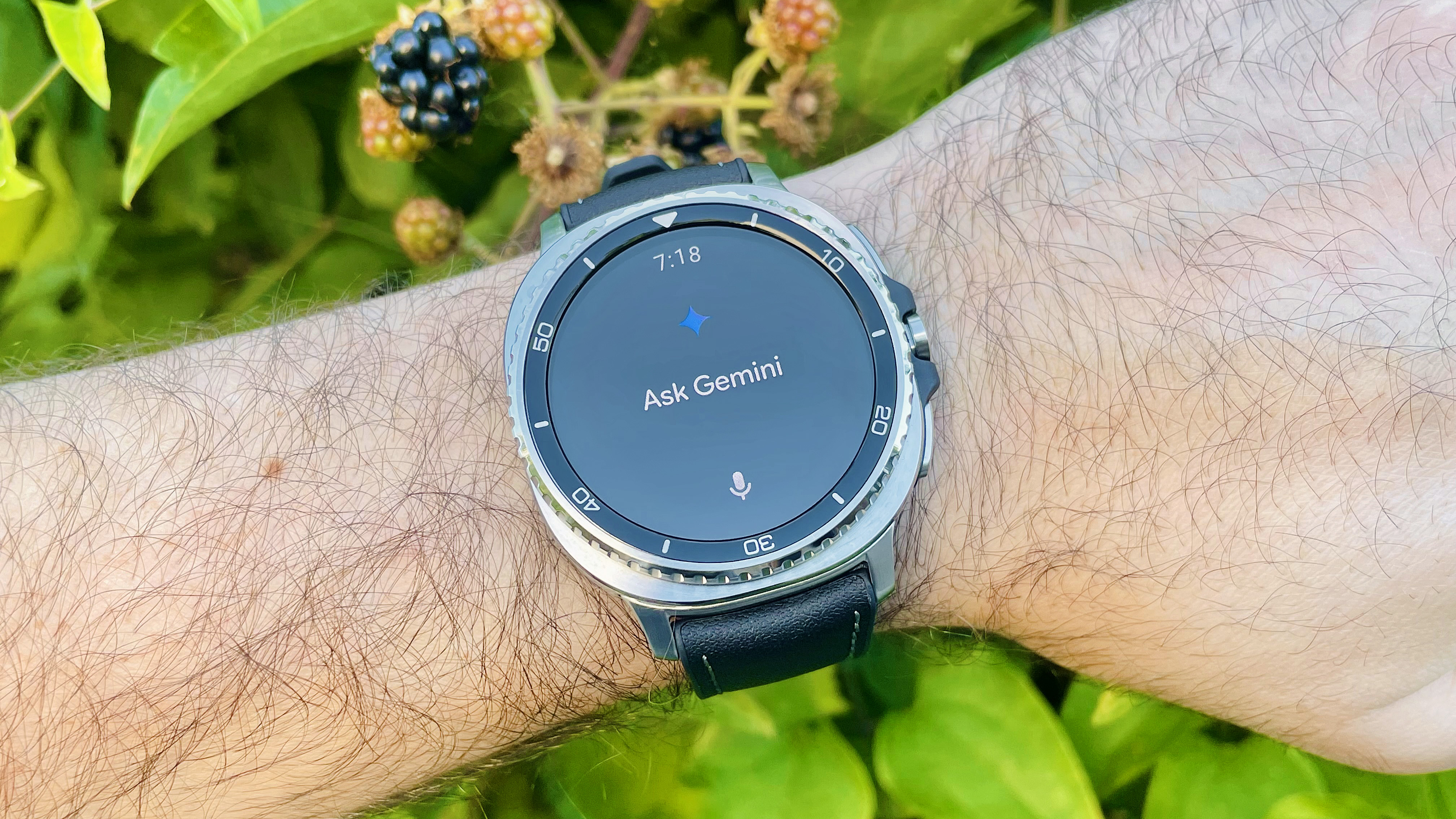 Close-up of the Samsung Galaxy Watch Classic on a user's wrist with the Gemini AI app open