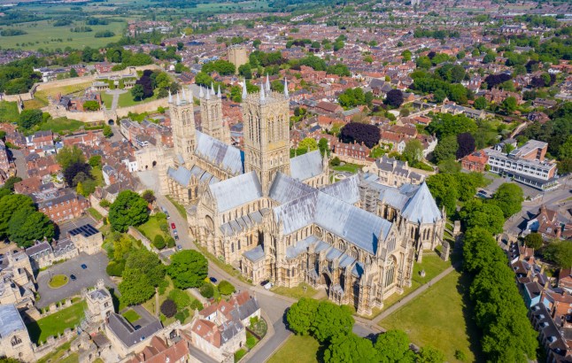 Lincoln UK, 20th May 2020: Aerial photo of the Lincoln Cathedral, Lincoln Minster in the city centre of Lincoln on a bright sunny summers day showing the historic Cathedral Church in the city centre; Shutterstock ID 1736955311; Purchase Order: -