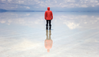 In the middle of the rainy season, a stretch of Bolivia's high desert turns into the largest mirror on the planet — a thin, perfectly still sheet of water spread across ten thousand square kilometers of salt, so exact that the sky and the ground become impossible to tell apart