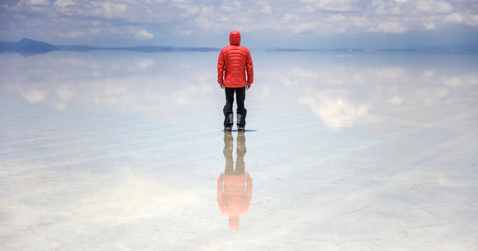 In the middle of the rainy season, a stretch of Bolivia's high desert turns into the largest mirror on the planet — a thin, perfectly still sheet of water spread across ten thousand square kilometers of salt, so exact that the sky and the ground become impossible to tell apart
