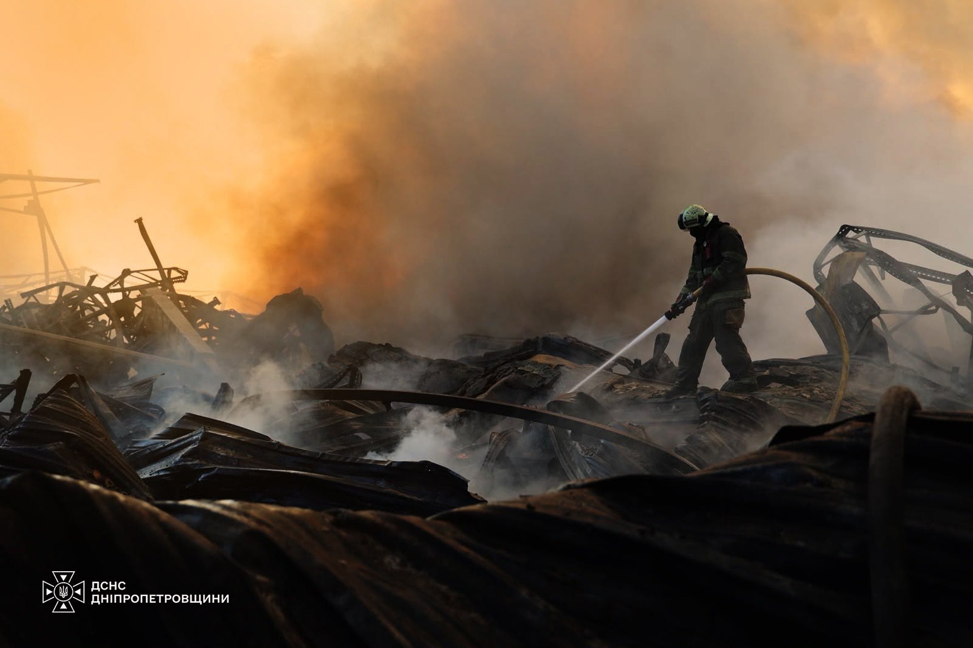 In this photo provided by the Ukrainian Emergency Service, a firefighter puts out a fire following a Russian missile attack in Dnipropetrovsk region, Ukraine, Tuesday, Aug. 4, 2026
