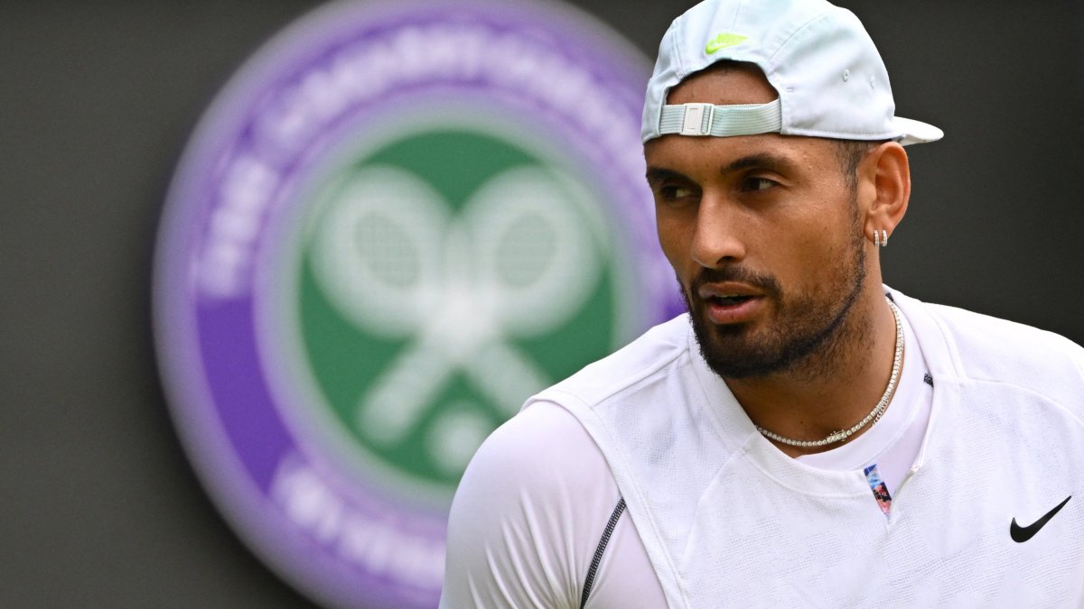 Australia's Nick Kyrgios reacts as he plays against Chile's Cristian Garin during their men's singles quarter final tennis match on the tenth day of the 2022 Wimbledon Championships at The All England Tennis Club in Wimbledon, southwest London, on July 6, 2022. (Photo by SEBASTIEN BOZON / AFP) / RESTRICTED TO EDITORIAL USE (Photo by SEBASTIEN BOZON/AFP via Getty Images)