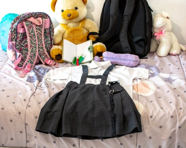 new uniform on bed in girl's room