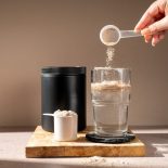 Protein shake and chocolate protein powder in a scoop, Sports nutrition.