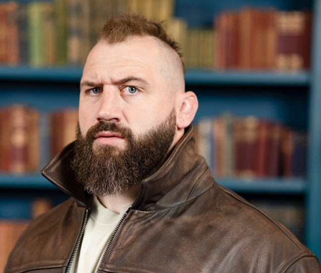 Joe Marler close up on The Traitors wearing a brown jacket and white top