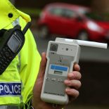 File photo dated 03/12/2014 of a Road Traffic constable holding a breathalyser, as Generation Z drivers are more likely to agree drink-driving has become more 