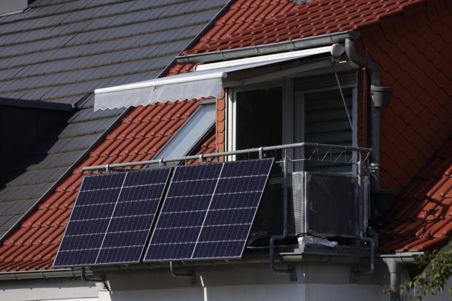 ERFURT, GERMANY - SEPTEMBER 01: Solar energy panels hang from a residential apartment balcony on September 01, 2024 in Erfurt, Germany. Many people in Germany have taken advantage of falling prices for solar panels combined with a government subsidy and eased German regulations to install solar energy panels on their balconies for home electricity production. (Photo by Sean Gallup/Getty Images)