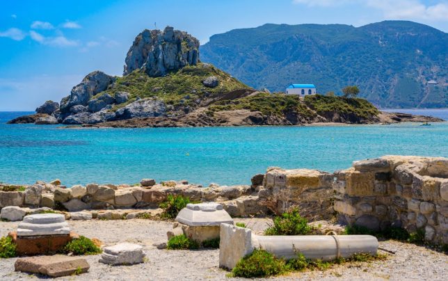Ruins of the Basilica St. Stefanos in front of beautiful Island Kastri - beautiful coast scenery of Kos, Greece