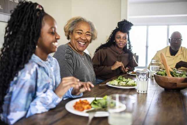 Multi-generational family talking at dining room table