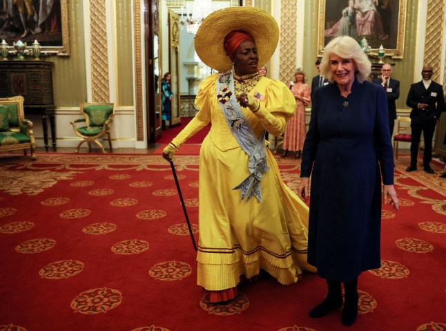 Britain's Queen Camilla walks with actor Sharon D Clarke, on the day she attends a reception for staff, actors and supporters of the National Theatre, at Buckingham Palace