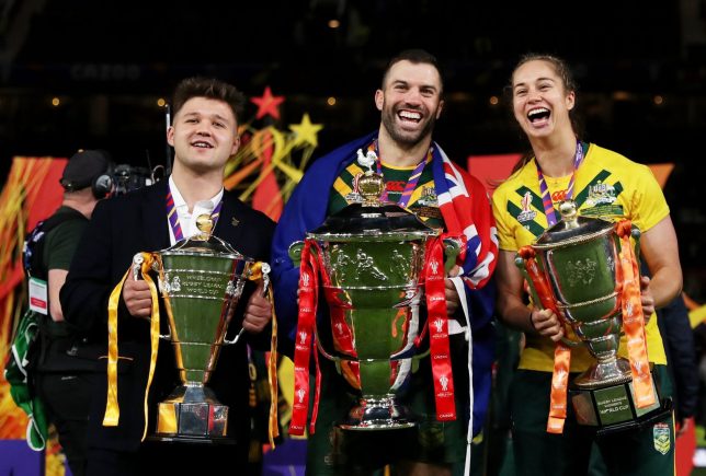 MANCHESTER, ENGLAND - NOVEMBER 19: Tom Halliwell of England Wheelchair, James Tedesco of Australia and Kezie Apps of Australia pose for a photograph with their trophies after the Rugby League World Cup Final match between Australia and Samoa at Old Trafford on November 19, 2022 in Manchester, England. (Photo by Lewis Storey/Getty Images for RLWC)