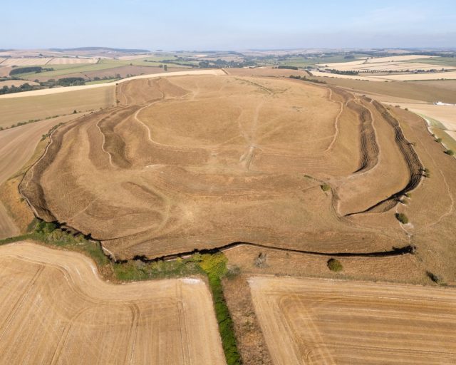DORCHESTER, ENGLAND - AUGUST 10: An aerial view of the dried out ground of Maiden Castle Iron Age hillfort, on August 10, 2026 in Dorchester, United Kingdom. Drought has been declared across seven areas of England; East Anglia; Hertfordshire and the whole of London; Thames Valley; Hampshire & the Isle of Wight; Devon & Cornwall; the West Midlands; Wessex (covering Dorset, Somerset, Wiltshire, and south Gloucestershire). (Photo by Finnbarr Webster/Getty Images)