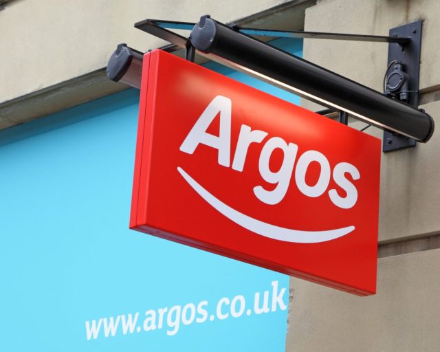 York,England-October 2nd,2011:A new modern hanging Argos sign with web address visable in background.Argos is the largest-goods retailer in the United Kingdom and Ireland with over 800 stores.It lets it customers browse for goods from it\'s comprehensive catalogues !