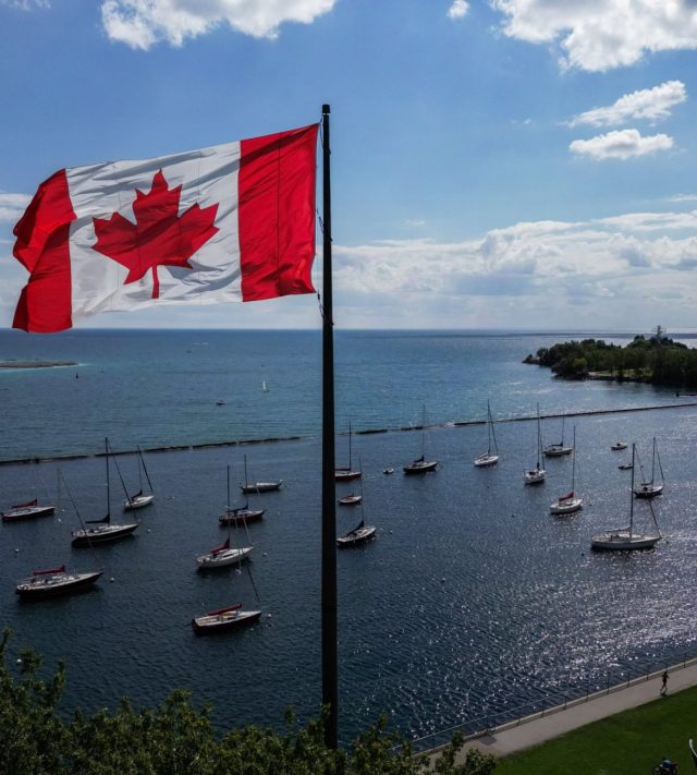 TOPSHOT - A Canadian flag flies along the waterfront of Lake Ontario, in Toronto, Ontario, Canada, on August 27, 2026. US President Donald Trump announced that he is renaming Lake Ontario -- a large body of water shared by the United States and Canada -- "Lake America." Trump signed an order in the White House in a move that comes amid a spiraling trade war between the world's largest economy and its northern neighbor. (Photo by Cole Burston / AFP via Getty Images)