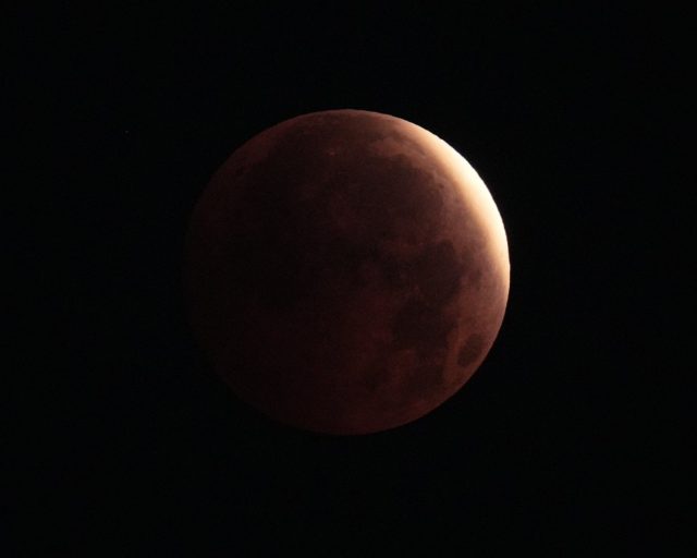 The partial lunar eclipse of the August full moon, known as the Sturgeon Moon, is seen in the skies over the Isle of Dogs, London. Picture date: Friday August 28, 2026. PA Photo. Photo credit should read: Yui Mok/PA Wire