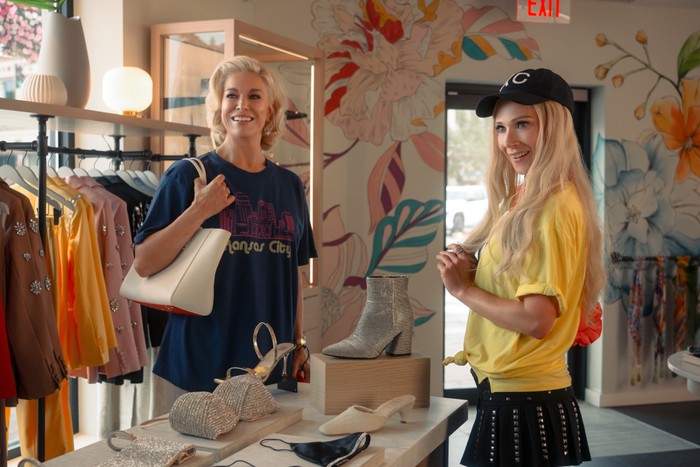 TedLasso-season4-Hannah-Juno Hannah Waddingham and Juno Temple in Ted Lasso season 4 standing in a store around a table, looking to the door and smiling.
