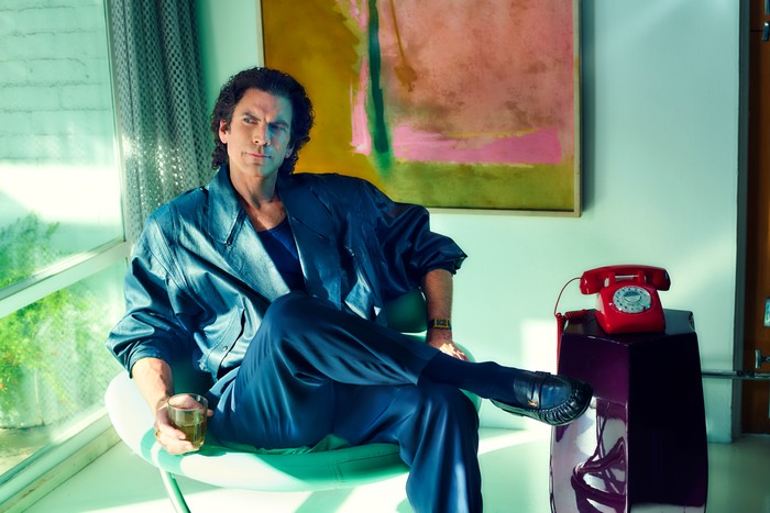 Wes Bentley as Terry Schaffer seated in a large oversized suit for The Shards.