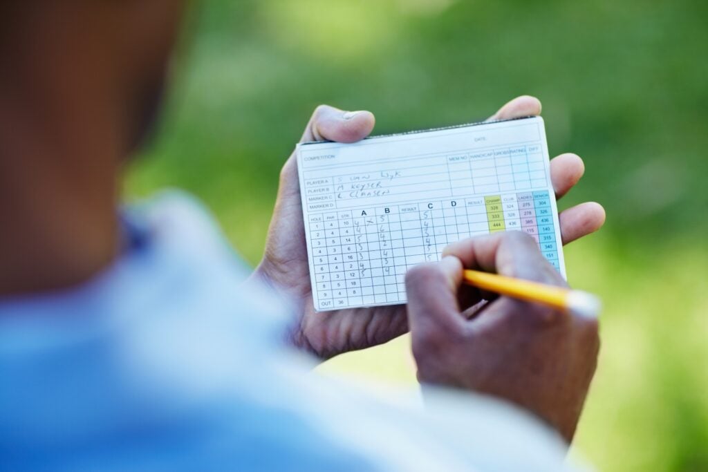 A player fills in a scorecard after a round | Source: Adobe Stock

18-handicap limit