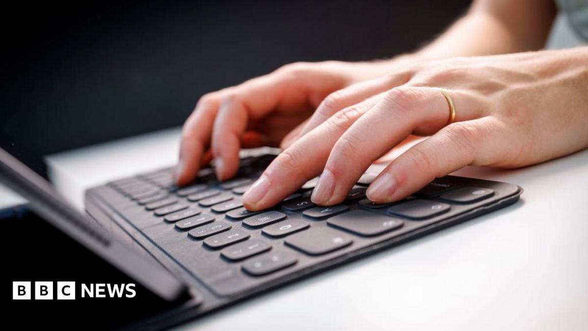 Library picture of two hands typing on a laptop