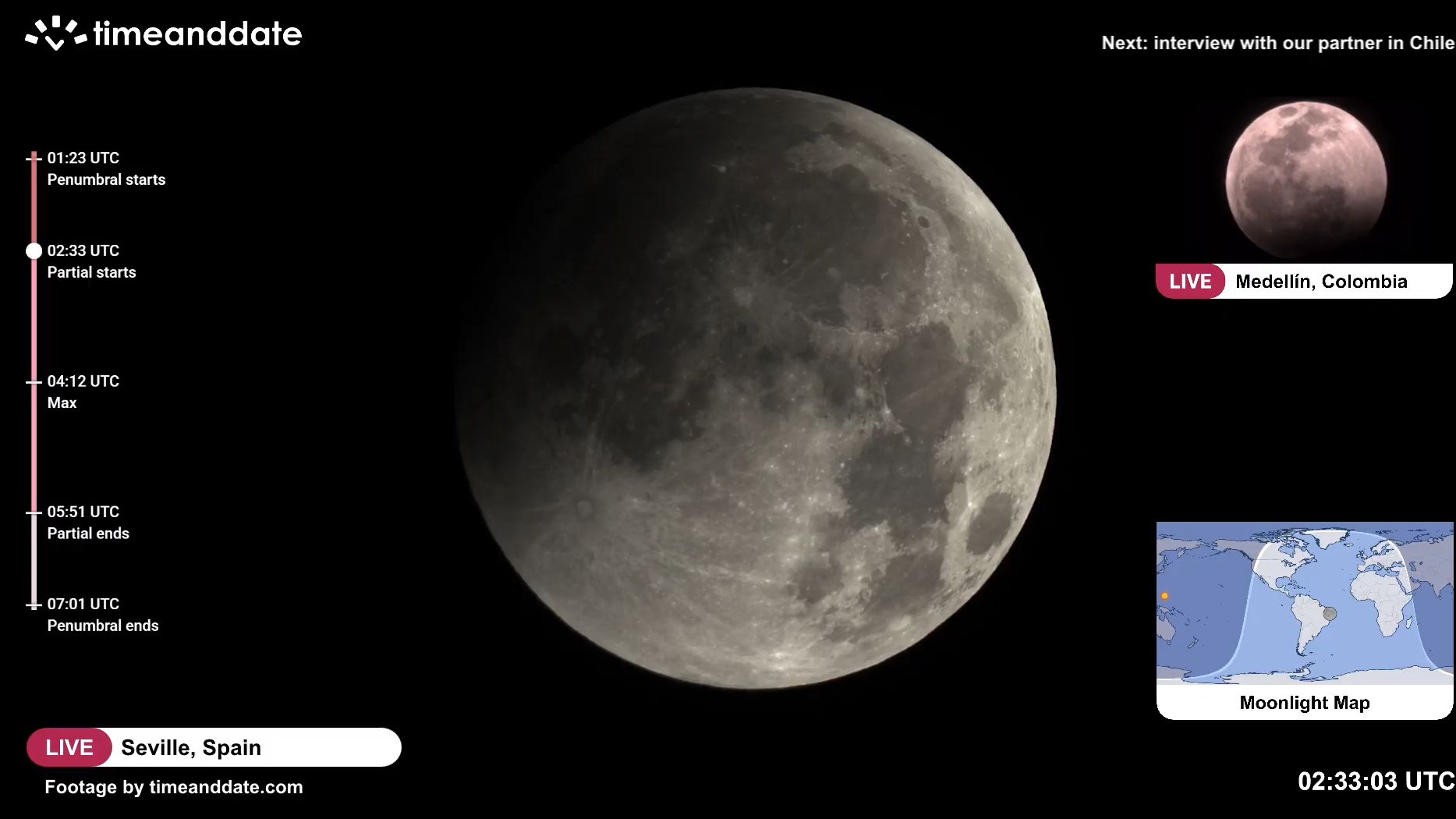 close up view of the moon in the night sky with a darker region to the upper left - the umbra has started moving onto the moon..