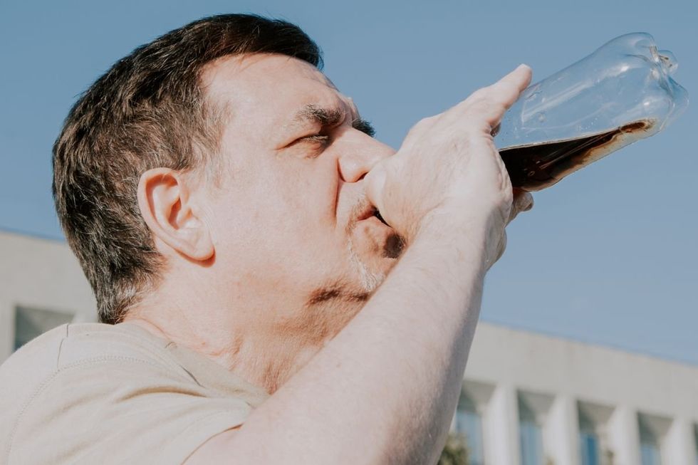 ADULT DRINKING COKE