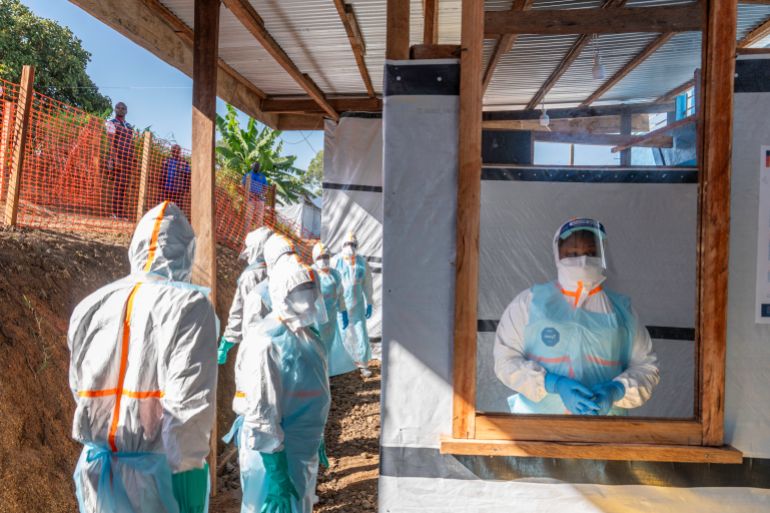 Health workers stand in a new Ebola treatment center during a visit of Tedros Adhanom Ghebreyesus, Director-General of the World Health Organization (WHO), in Bunia, in the northeastern Democratic Republic of the Congo. [May 31: AFP]