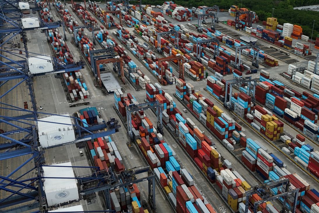 Containers sit stacked as cranes load and unload containers from cargo ships at the Panama Canal's Balboa port in Panama City on July 24.
