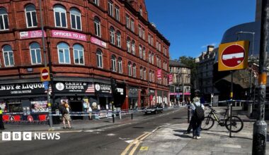 Police tape outside of a shop and across a road in Birmingham city centre.