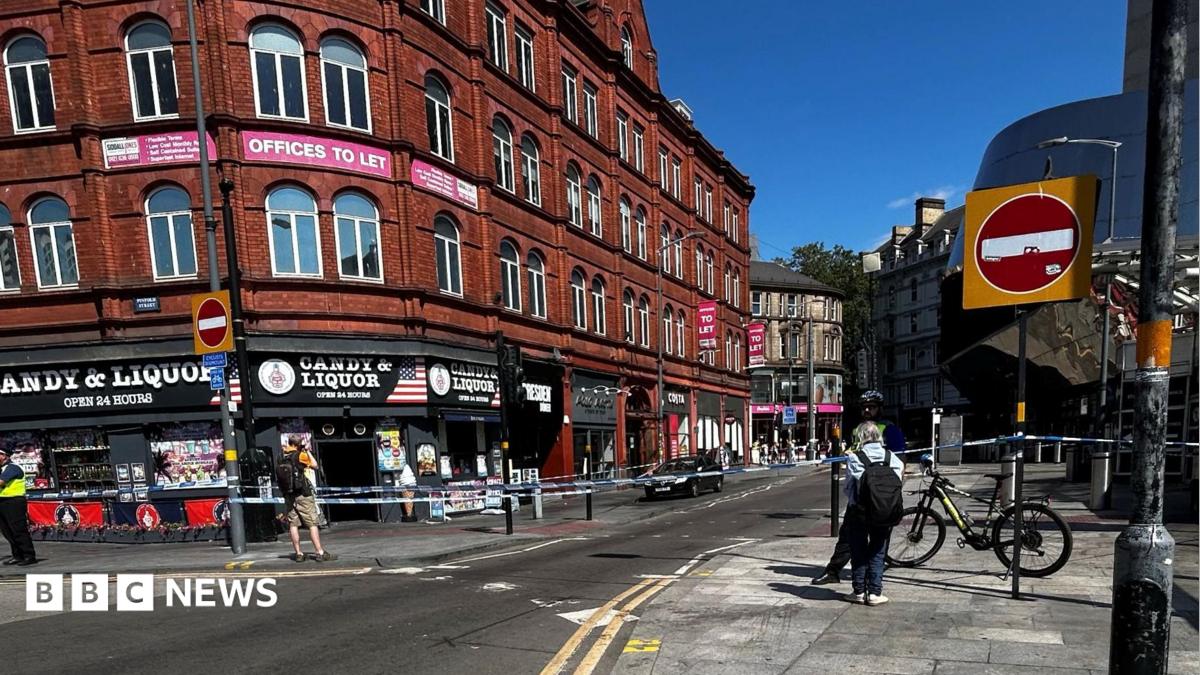 Police tape outside of a shop and across a road in Birmingham city centre.