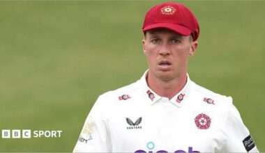 Nathan McSweeney in a white Northamptonshire shirt and claret baseball cap during a match